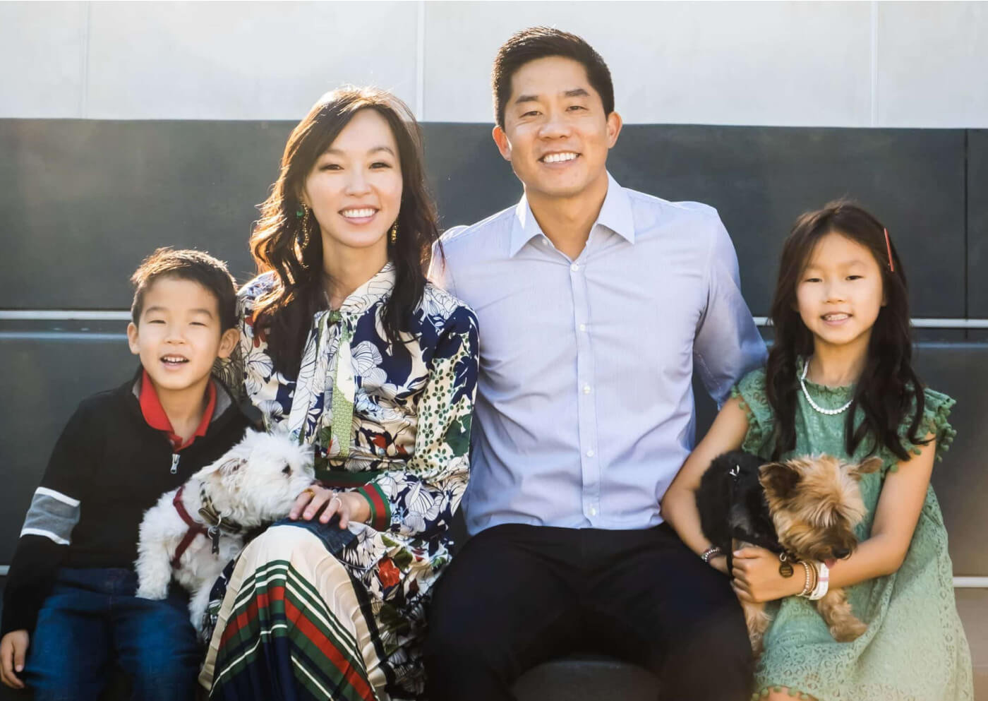 smiling family with their dogs